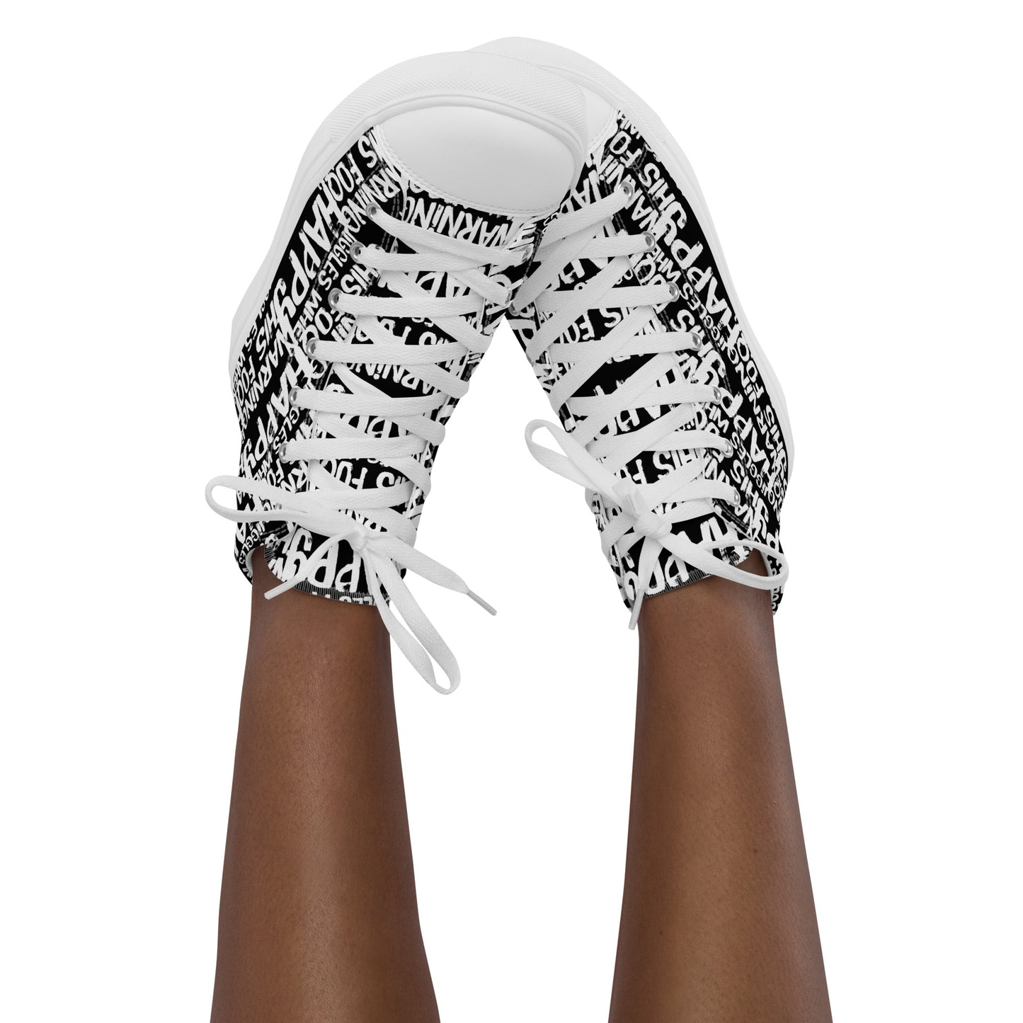 Womans feet in the air tapping toes of her high tops playful black and white print Warning This Foot Jiggles When Happy
