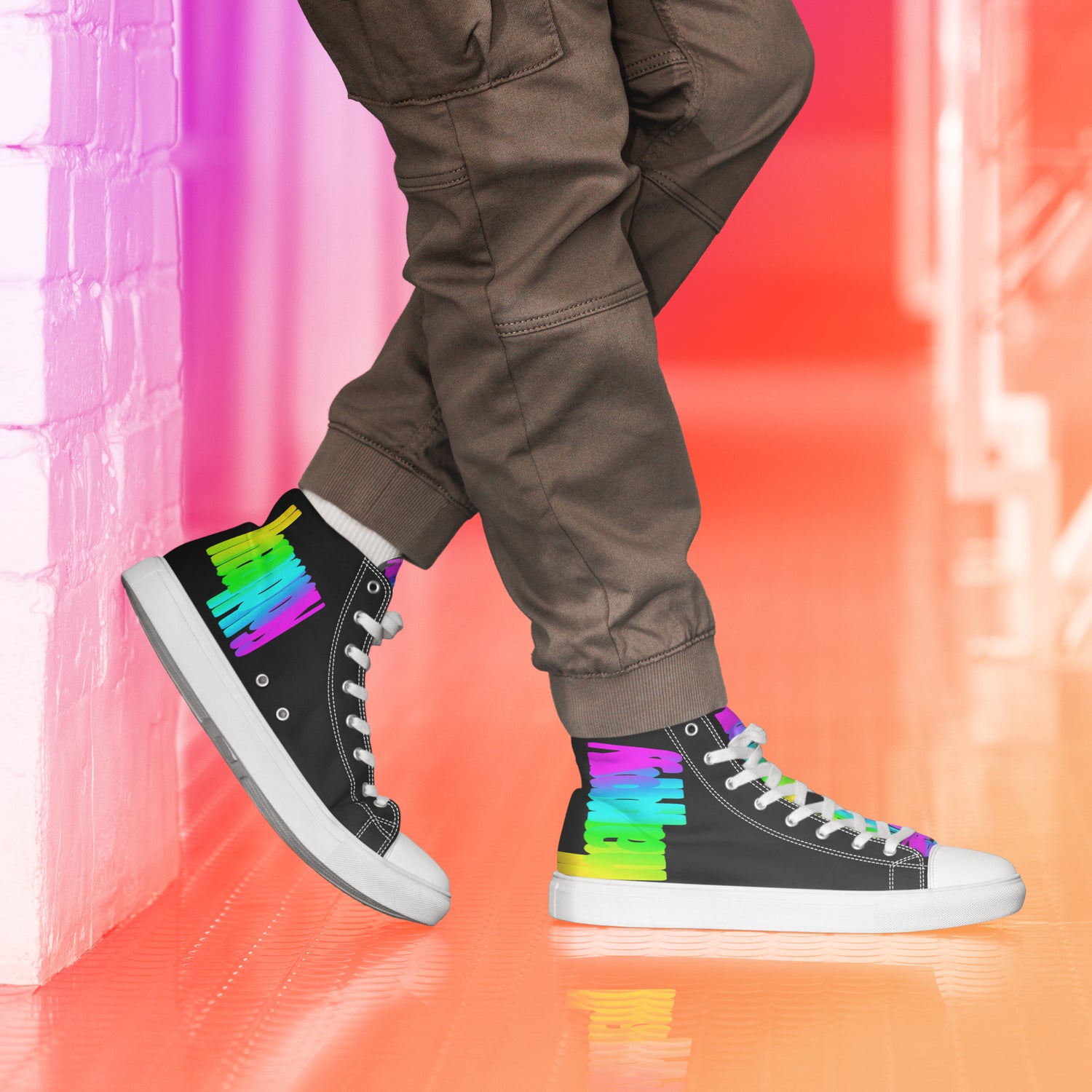 Happy Rainbow Painted spectrum colours on black high tops HappyStuff brand mens sneakers side view knees down left heel propped on wall