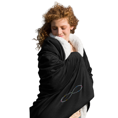 Cozy happy young woman wrapped in soft black sherpa throw blanket with a happy embroidered infinity symbol HappyStuff