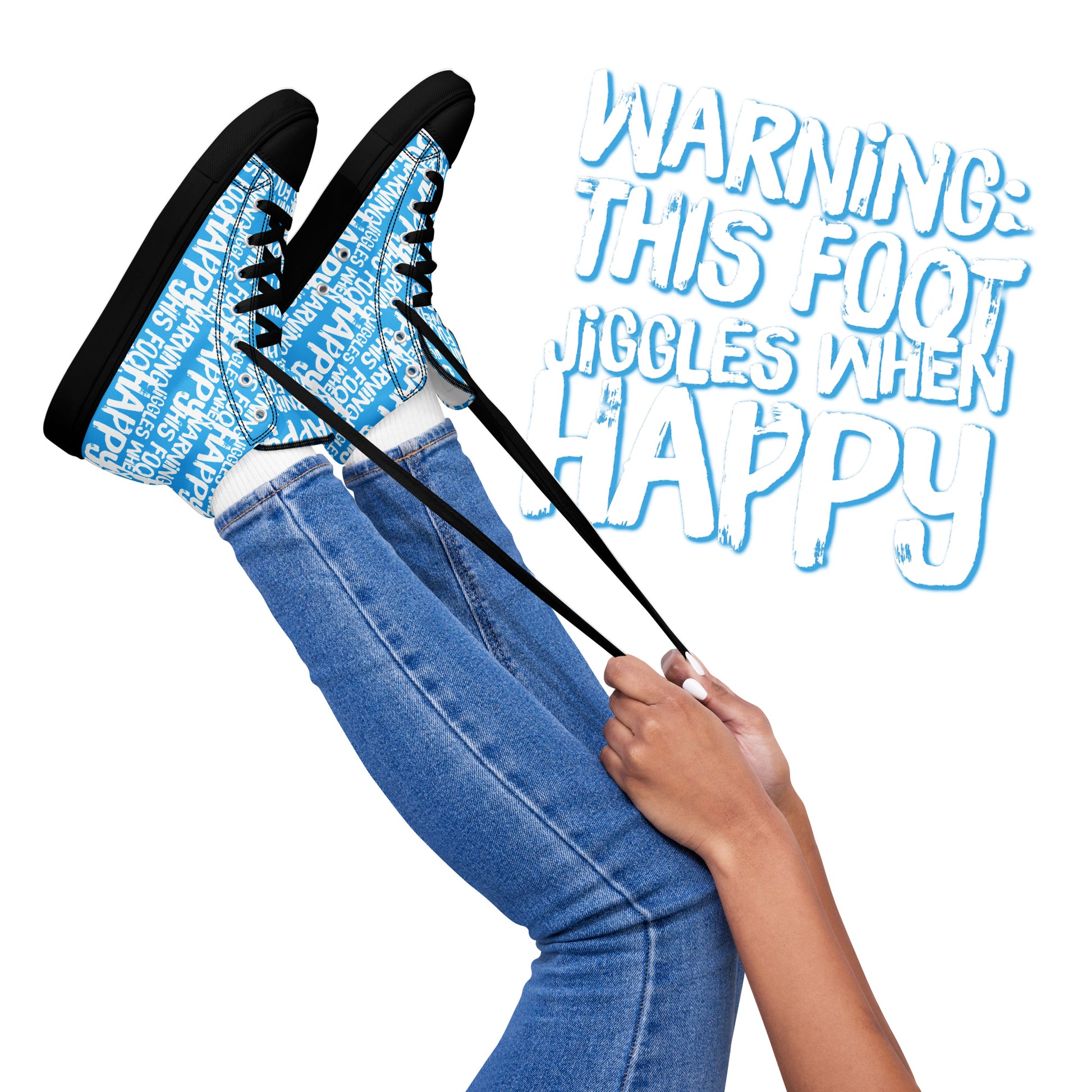 Womens feet in the air holding laces of HappyStuff blue and white high tops fun print Warning This Foot Jiggles When Happy black sole