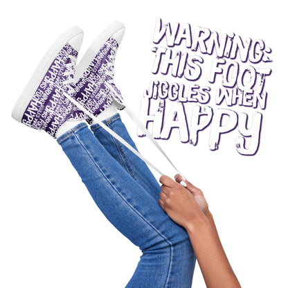 Womens feet in the air holding laces of HappyStuff purple and white high tops fun print Warning This Foot Jiggles When Happy