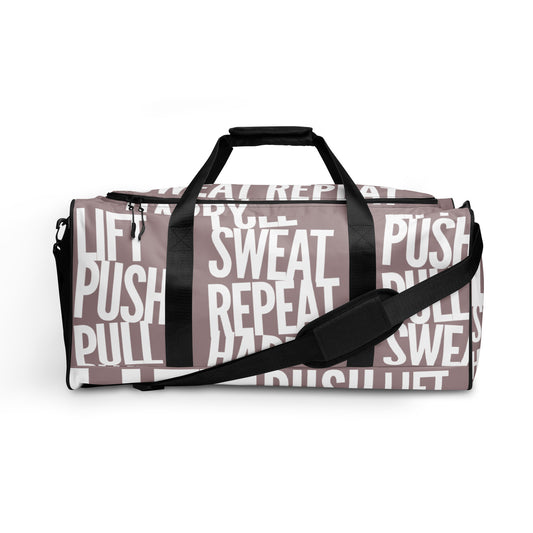 Side view Duffle bag Lift Push Pull Sweat Repeat Happy all over print taupe and white gym bag adjustable shoulder strap padded handles HappyStuff Brand