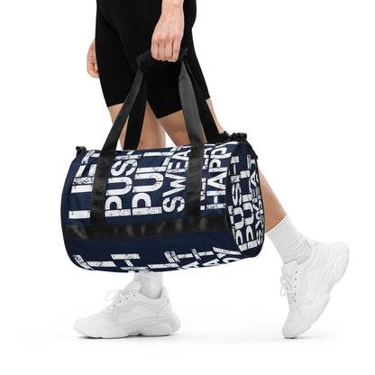 Woman carrying gym bag navy blue and white all over print Lift Push Pull Sweat Repeat Happy small duffle bag black detail HappyStuff Brand padded handles