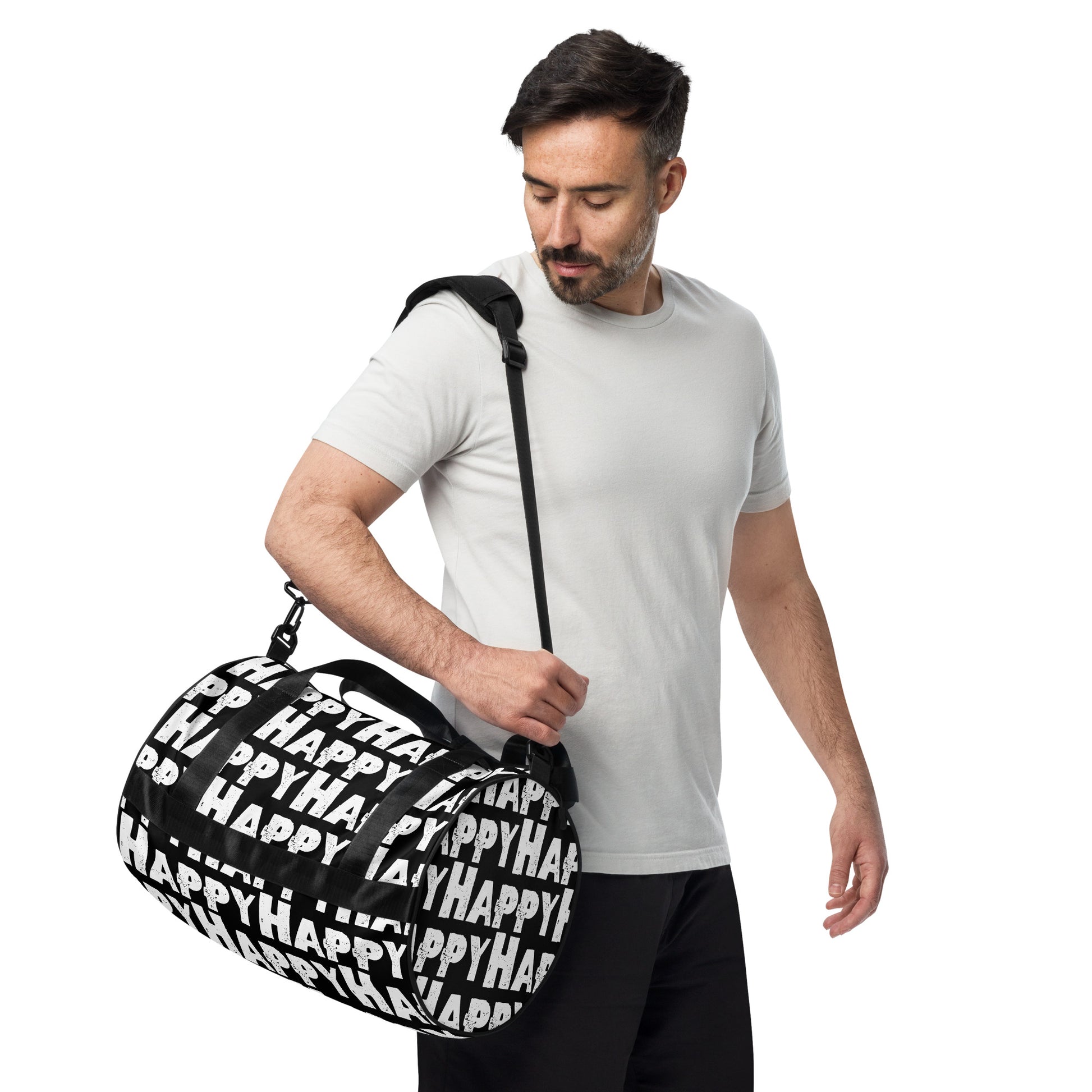 Man carrying gym bag adjustable removable padded shoulder strap black and white small duffle bag Happy sponge print HappyStuff Brand