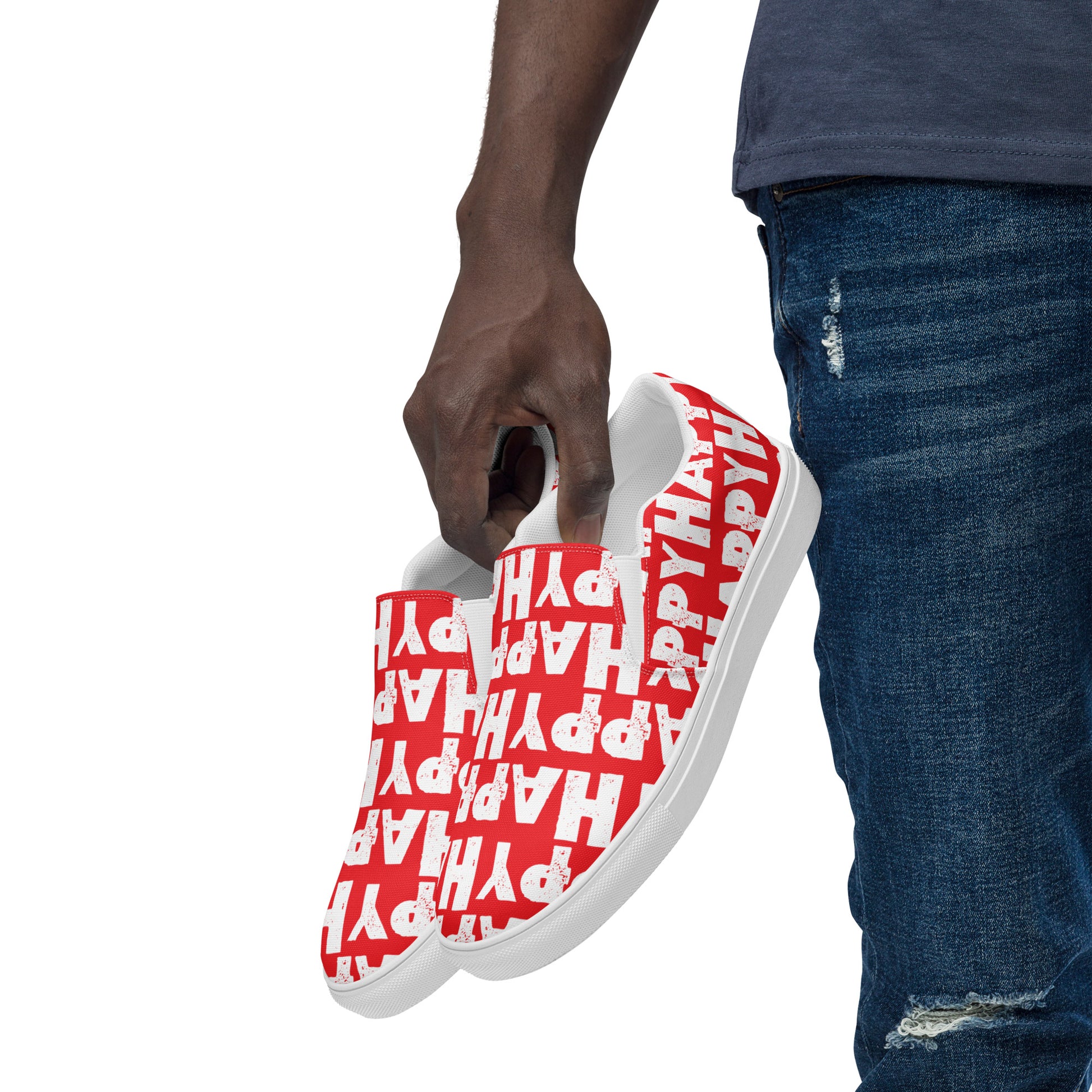 Mans hand holding happy shoes at his side fun red and white sneakers Happy Sponge Printed HappyStuff canvas slip on shoes