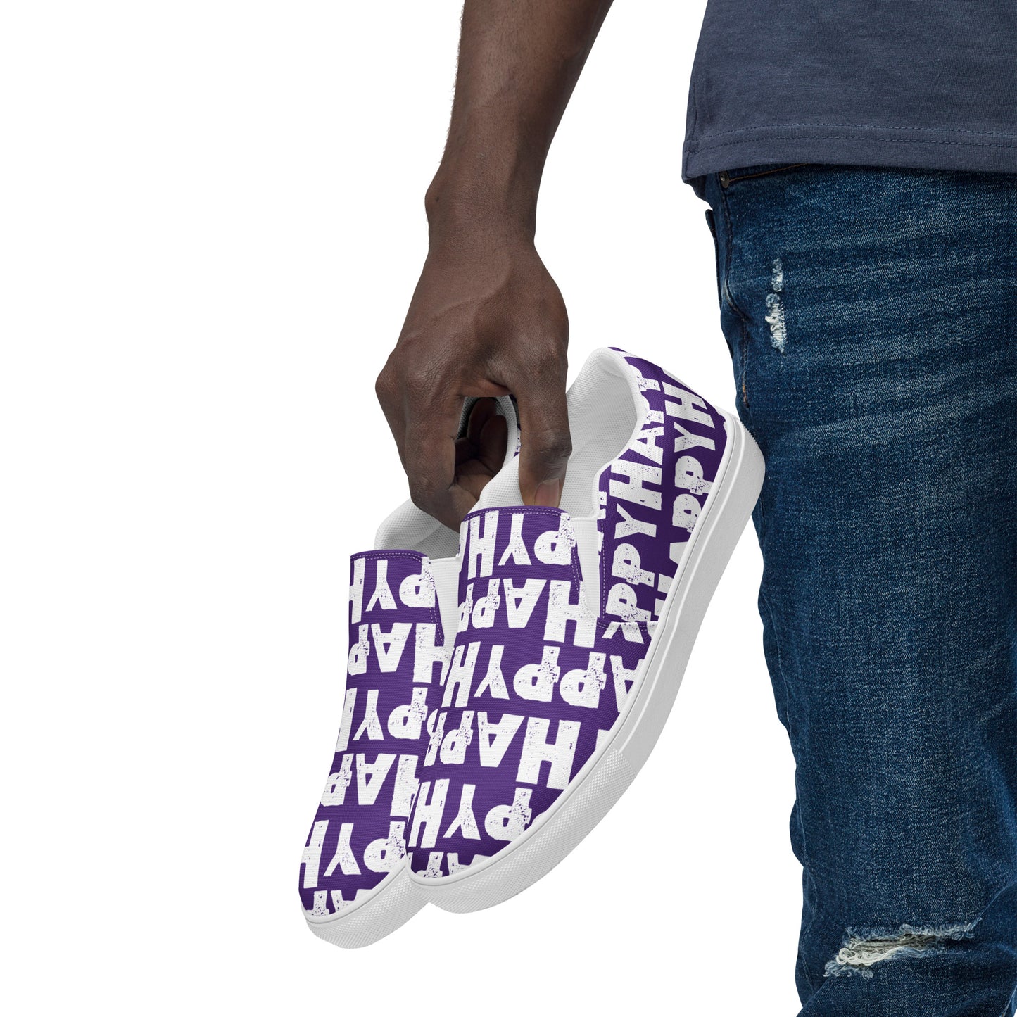 Mans hand holding happy shoes at his side fun purple and white sneakers Happy Sponge Printed HappyStuff canvas slip on shoes