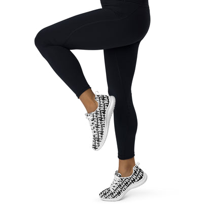 Happy Sponge Print lightweight black sneakers HappyStuff brand athletic shoes worn by a woman in tights prancing away to the left