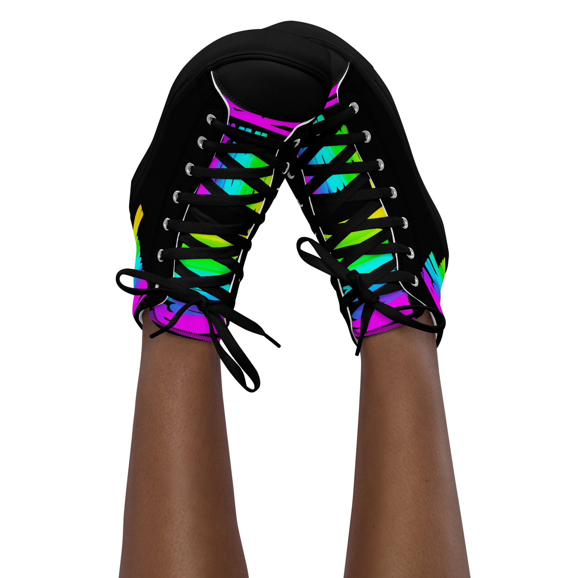 Feet in the air wearing womens sneakers tapping toes of her Happy Rainbow Painted bright colour spectrum print black high tops black sole