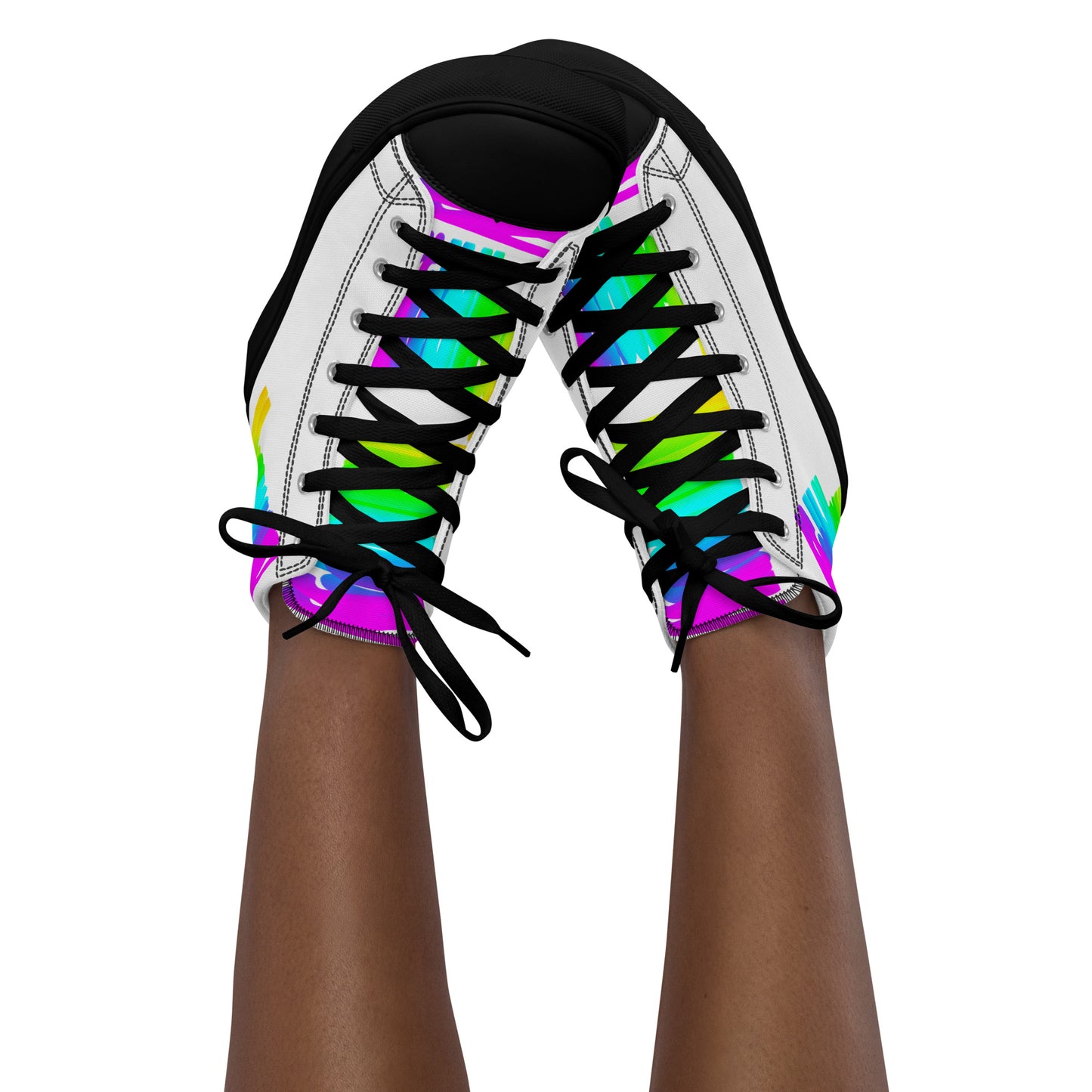 Feet in the air wearing womens sneakers tapping toes of her Happy Rainbow Painted bright colour spectrum print white high tops black sole