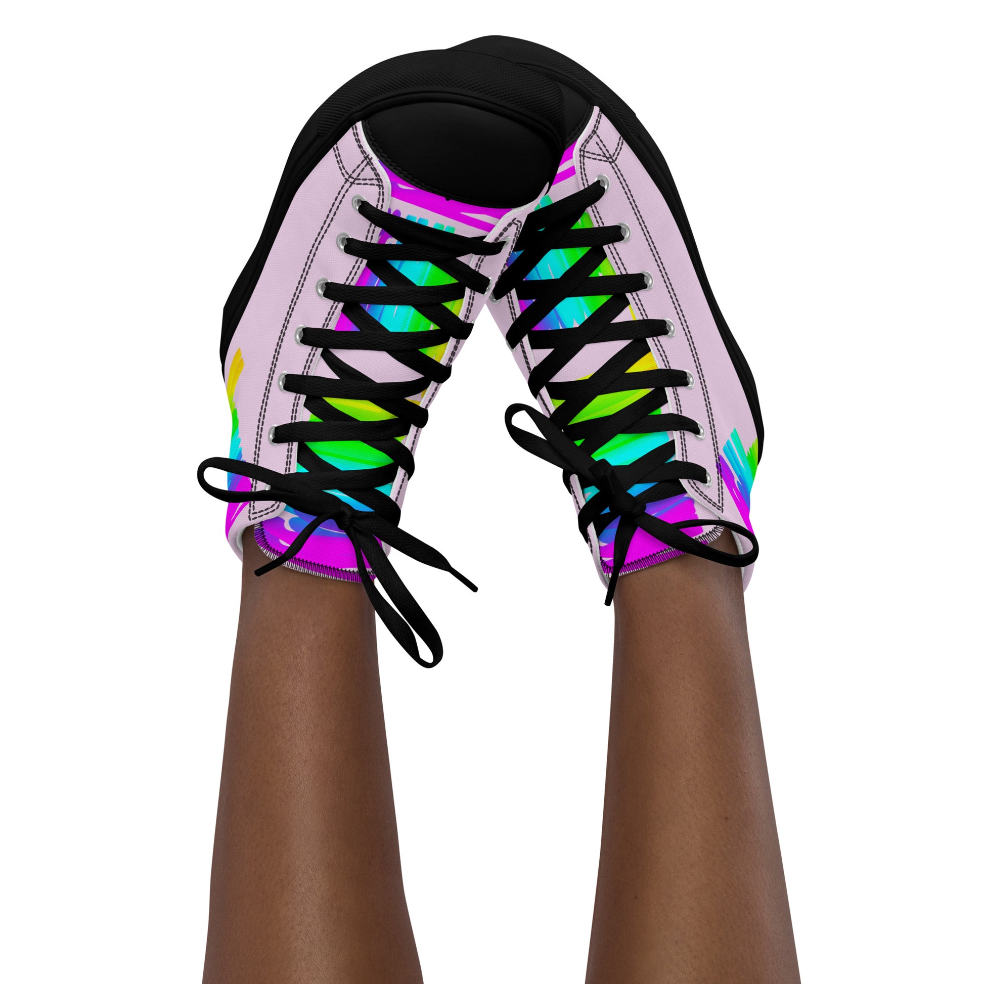 Feet in the air wearing womens sneakers tapping toes of her Happy Rainbow Painted bright colour spectrum print pink high tops black sole