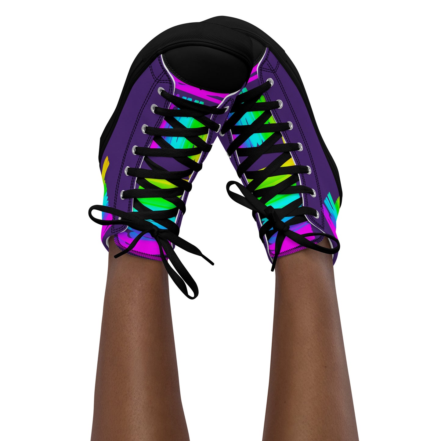 Feet in the air wearing womens sneakers tapping toes of her Happy Rainbow Painted bright colour spectrum print purple high tops black sole