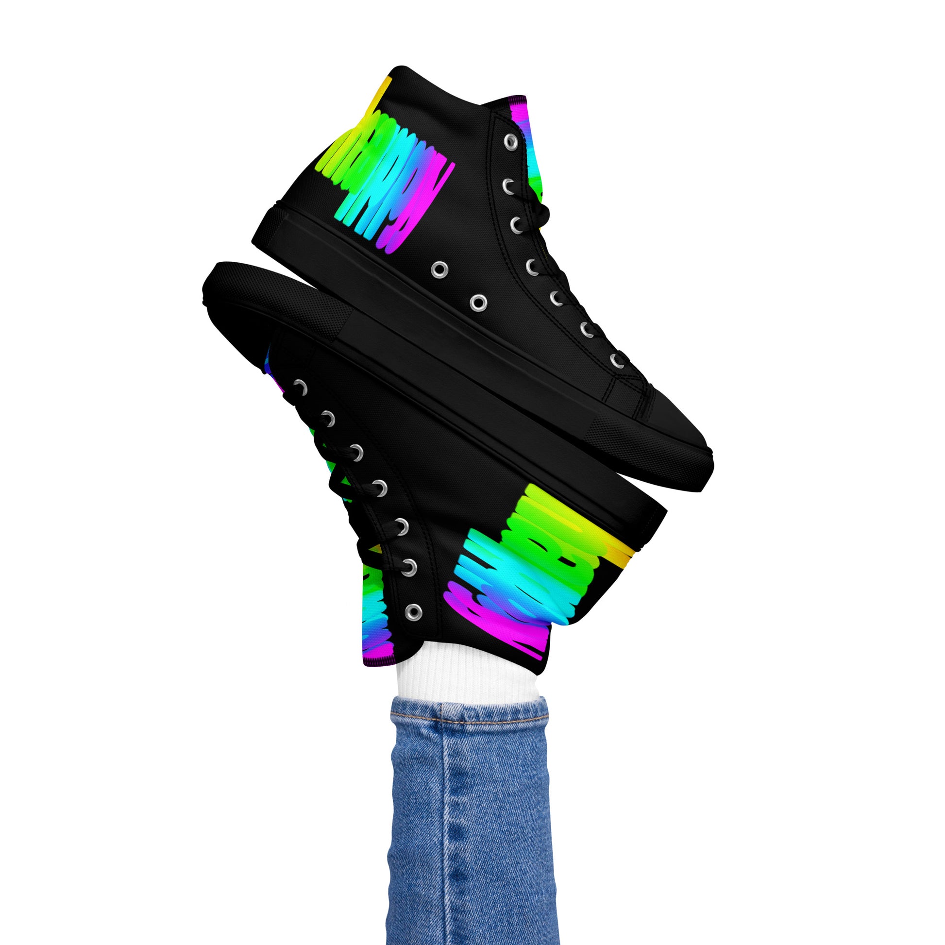 Womans right foot propping up Happy Rainbow Painted bright colour spectrum print black high tops black sole balancing left sneaker atop