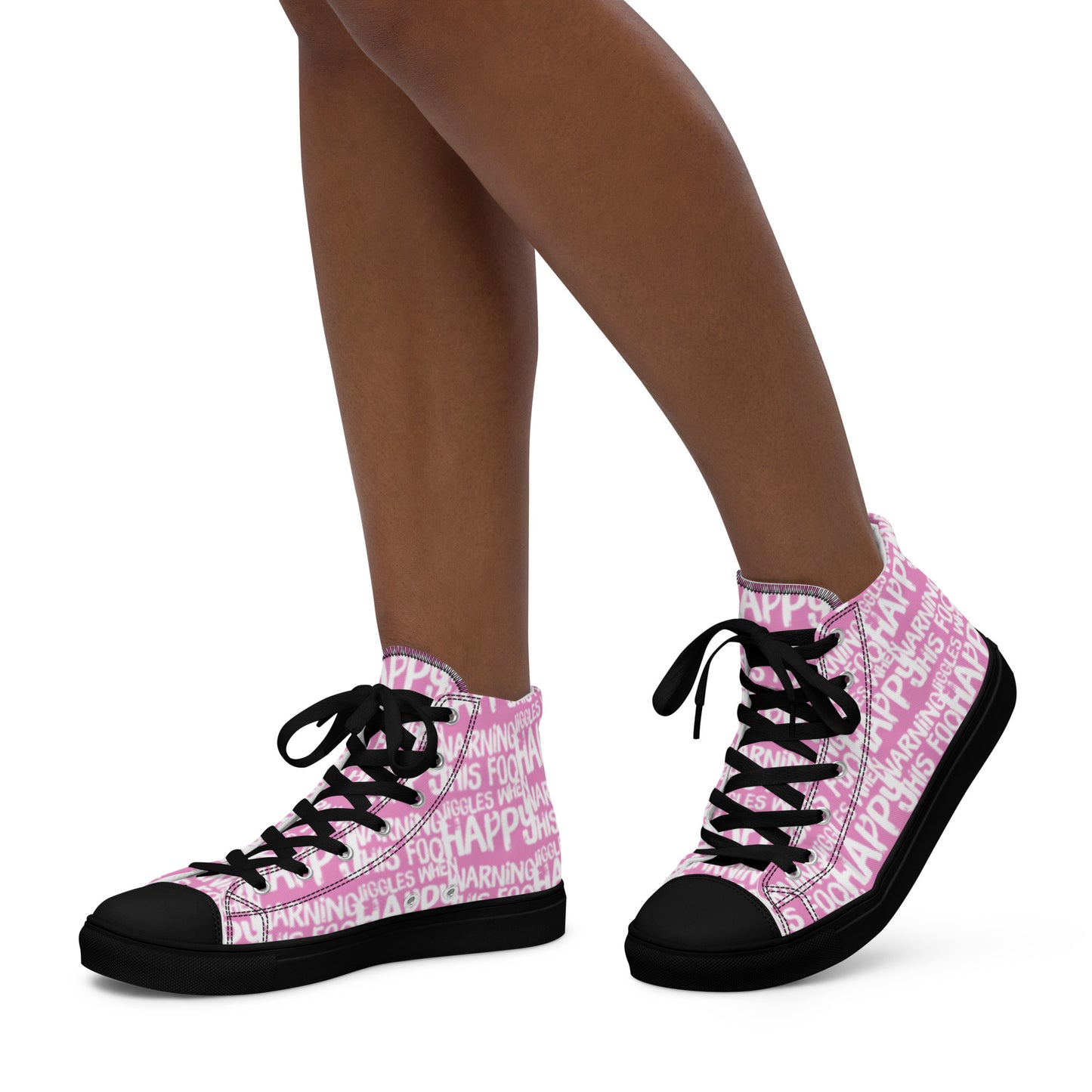 Womans feet walking in HappyStuff brand high top sneakers playful pink and white print Warning This Foot Jiggles When Happy black sole