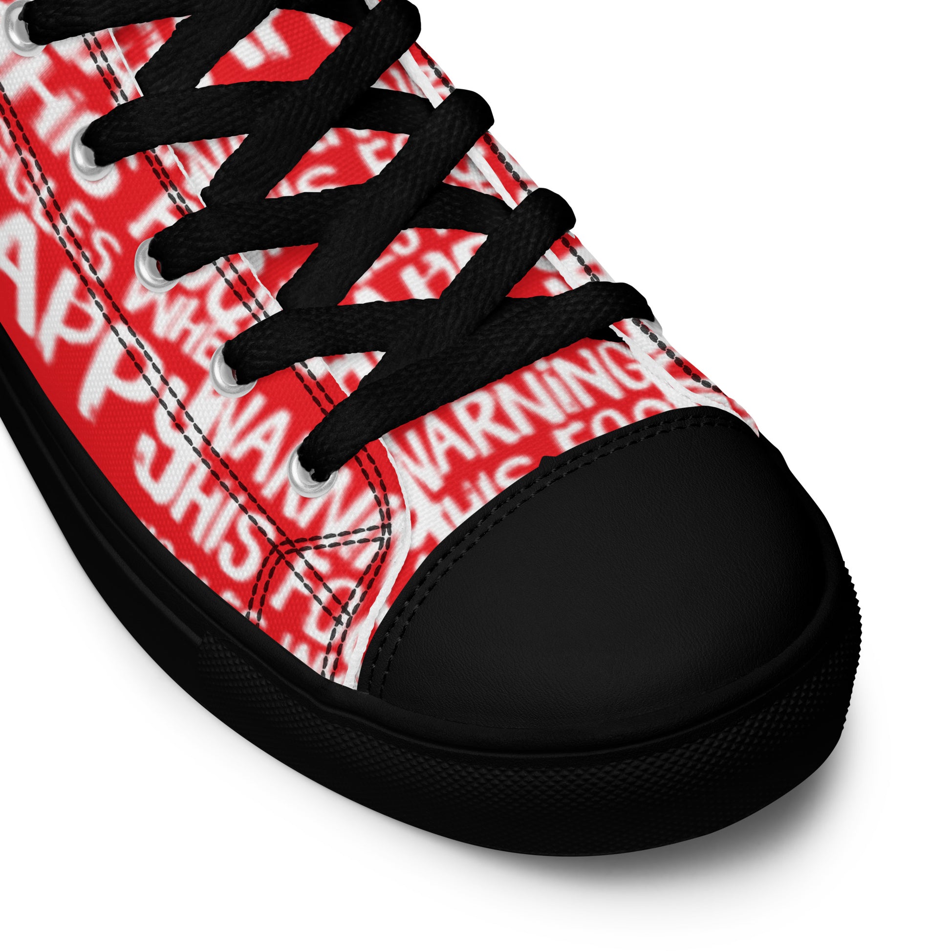 HappyStuff red high tops with playful white print Warning This Foot Jiggles When Happy black laces faux leather toe cap closeup black sole