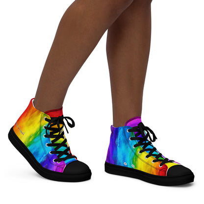 Close up of rainbow shoes on a woman walking right holi colours printed on white high tops HappyStuff sneakers fun shoes black sole