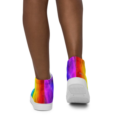 Close up of rainbow shoes on a woman walking away holi colours printed on white high top sneakers HappyStuff brand logo on right shoe