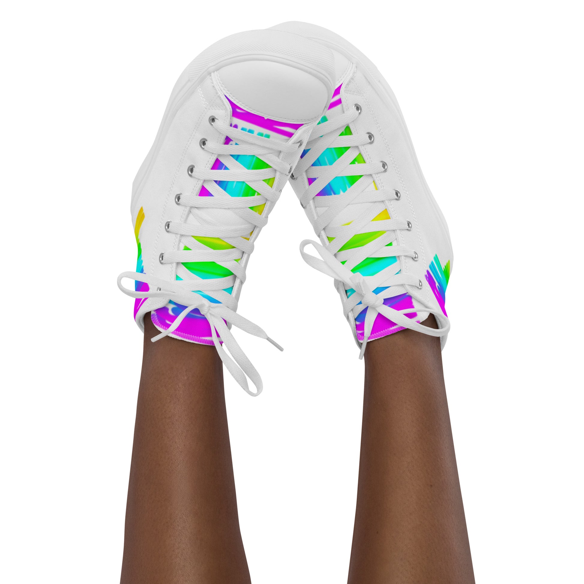 Feet in the air wearing womens sneakers tapping toes of her Happy Rainbow Painted bright colour spectrum print white high tops