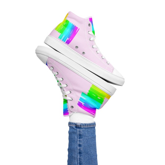 Womans right foot propping up Happy Rainbow Painted bright colour spectrum print pink high tops balancing left sneaker atop