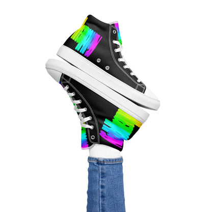 Womans right foot propping up Happy Rainbow Painted bright colour spectrum print black high tops balancing left sneaker atop