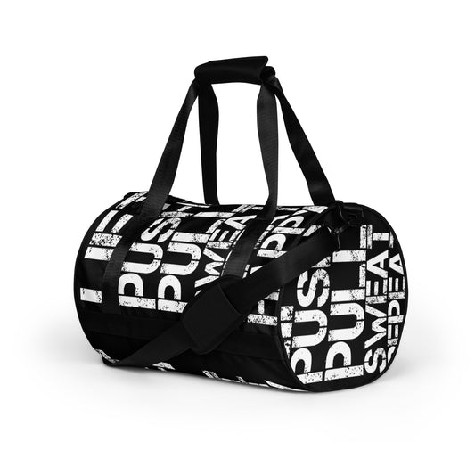 Gym bag black and white all over print Lift Push Pull Sweat Repeat Happy small duffle bag angled side view showing handles and strap HappyStuff Brand 