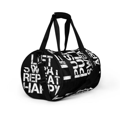 Gym bag black and white all over print Lift Push Pull Sweat Repeat Happy small duffle bag angled side view showing handles, strap and end pocket HappyStuff Brand