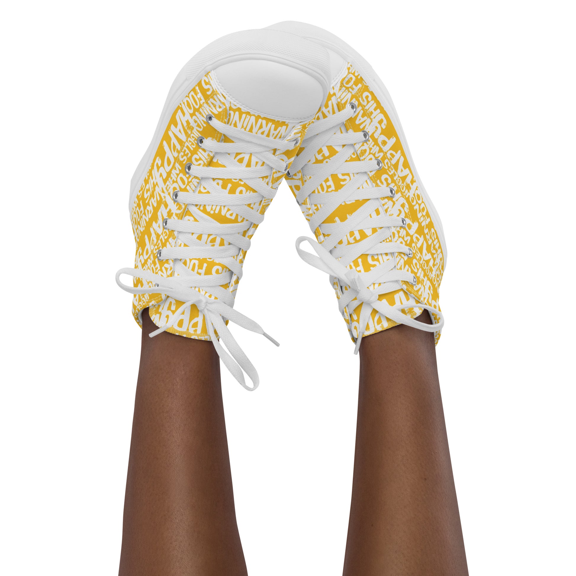 Womans feet in the air tapping toes of her high tops playful yellow and white print Warning This Foot Jiggles When Happy