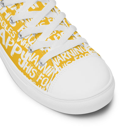 HappyStuff yellow high tops with playful white print Warning This Foot Jiggles When Happy white laces faux leather toe cap closeup