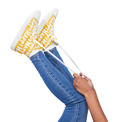 Womans feet playfully showing HappyStuff high tops canvas sneakers white laces Happy sponge printed yellow and white shoes